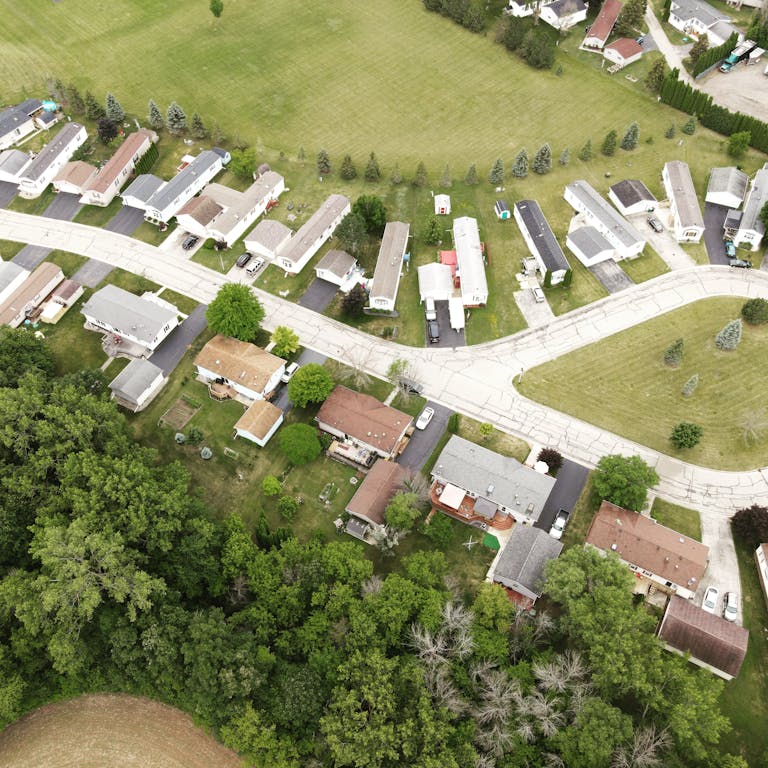 Aerial view of a suburban neighborhood in Fond du Lac, Wisconsin, showcasing houses and greenery.